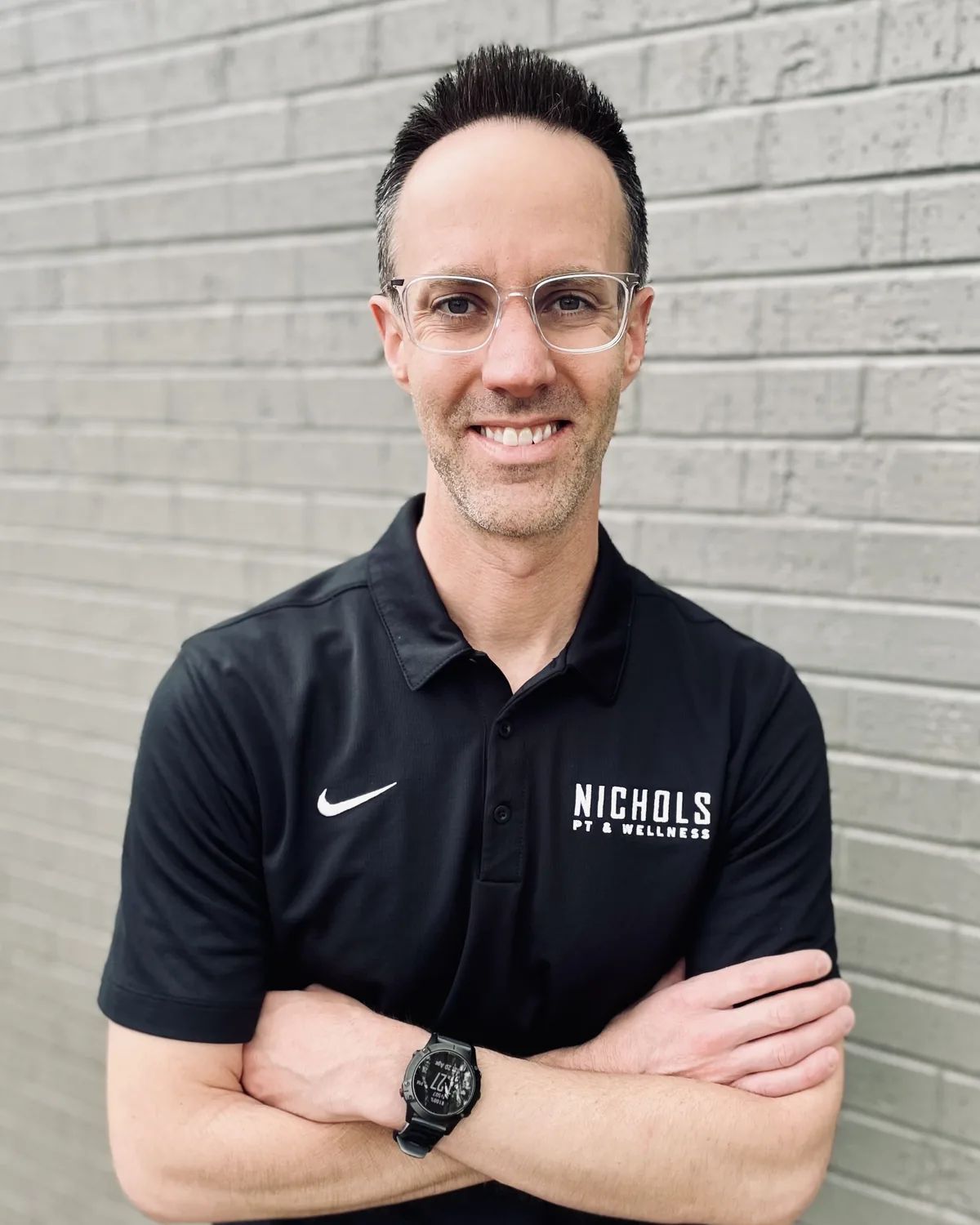 Dr. Travis Nichols, physical therapist, in a black Nichols PT & Wellness polo